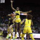 West Virginia guard Kysre Gondrezick, left, shoots past Baylor center Queen Egbo, center, in the first half of an NCAA college basketball game, Monday, March 8, 2021, in Waco, Texas. (Rod Aydelotte/Waco Tribune-Herald via AP)