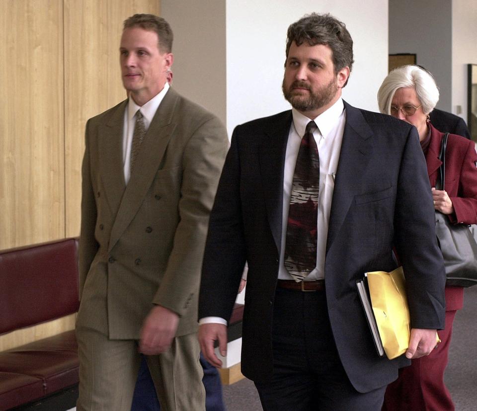 Oakland police officer Matthew Hornung, left, and his attorney Ed Fishman exit a courtroom Dec. 6, 2000, at Alameda County Superior Court in Oakland, Calif. Hornung and other officers were charged in "The Riders" scandal.