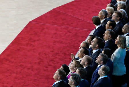 Britain's Prime Minister Theresa May, German Chancellor Angela Merkel, European Council President Donald Tusk, Dutch Prime Minister Mark Rutte and Hungarian Prime Minister Viktor Orban react as they pose for a group photo at the ASEM leaders summit in Brussels, Belgium October 19, 2018. REUTERS/Piroschka van de Wouw