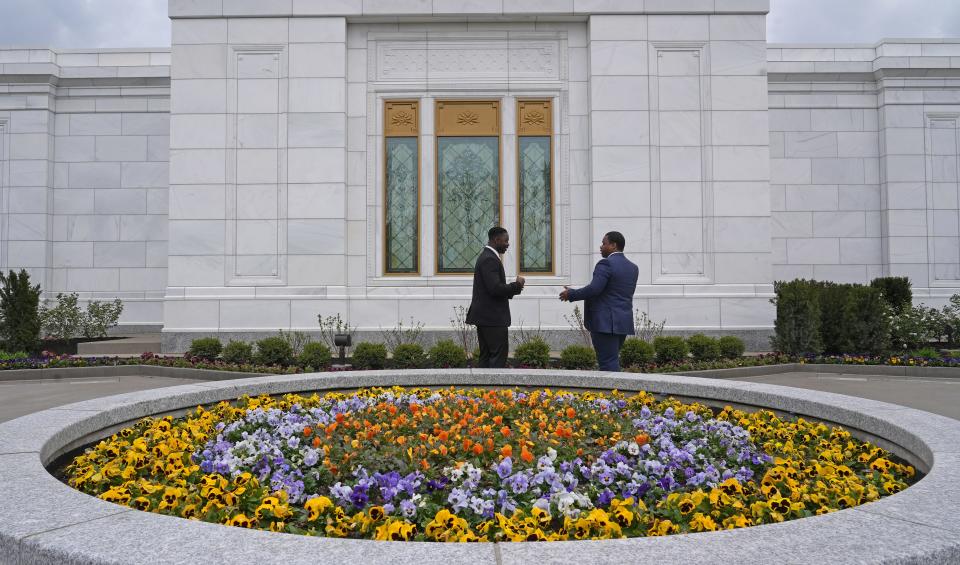 Billings Amoah, left, and Seanquez Frye talk outside the temple of The Church of Jesus Christ of Latter-day Saints in Columbus' West Side during an open house there Monday. The temple, usually closed to the public, has undergone renovations and will be open to the general public for scheduled visits from April 29 through May 13. After that, the temple will become restricted once again — possibly for decades to come.