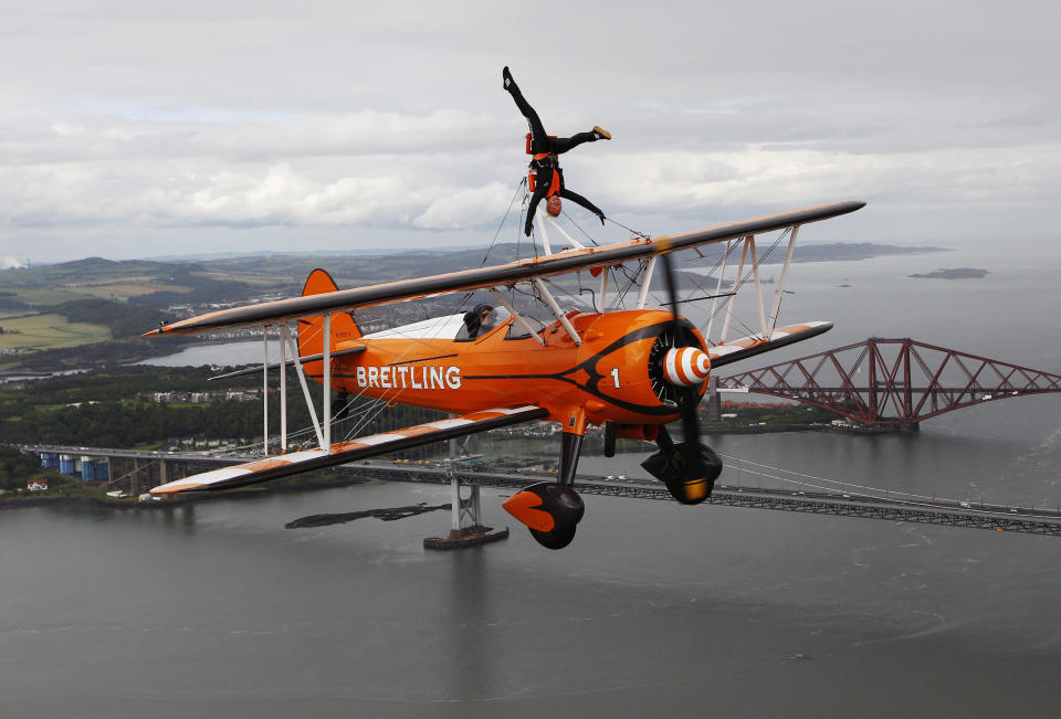 Team Breitling wingwalker Charlotte Voce performs, in advance of their appearance at Saturday's airshow at the National Museum of Flight at East Fortune, over the Firth of Forth in Scotland July 22, 2011. REUTERS/David Moir