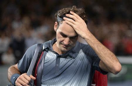 Roger Federer of Switzerland leaves the court after being defeated by Novak Djokovic of Serbia in their semi-final match at the Paris Masters men's singles tennis tournament at the Palais Omnisports of Bercy in Paris, November 2, 2013. REUTERS/Christophe Saidi/Pool