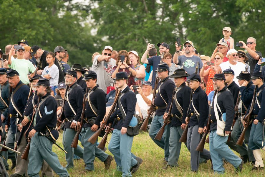 Spectators watch reenactors during the 160th reenactment of the Battle of Gettysburg, at Daniel Lady Farm in Gettysburg, Pennsylvania, on June 30, 2023. The Battle of Gettysburg, which is considered to be the bloodiest battle ever fought on US soil, occurred from July 1-July 3, 1863 during the US Civil War. Approximately 10,000 Union and Confederate troops were left dead, and another 30,000 wounded. Each year, the Gettysburg Battlefield Preservation Association holds a reenactment on the weekend closest to the original battle, hosting living history demonstrations and military reenactments to help teach people the history of the Civil War battle. (Photo by Stefani Reynolds / AFP) (Photo by STEFANI REYNOLDS/AFP via Getty Images)