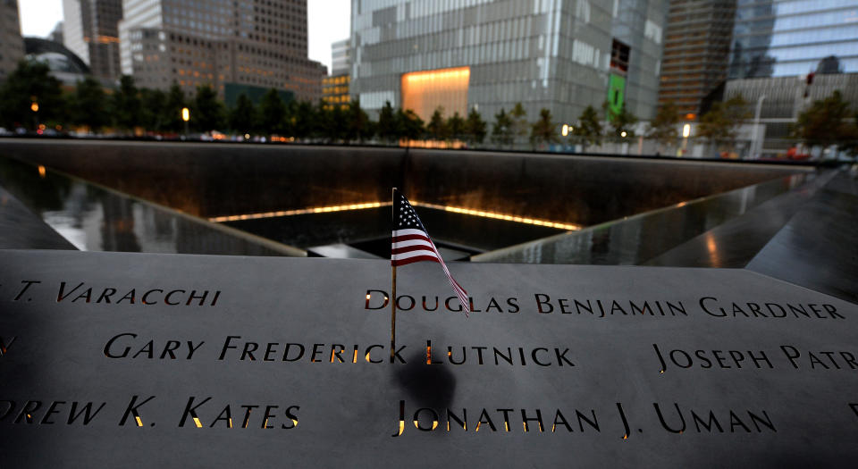 NEW YORK, NY - SEPTEMBER 11: An American flag is placed in an inscribed name along the edge of the North Pool during memorial observances held at the site of the World Trade Center on September 11, 2014 in New York City. This year marks the 13th anniversary of the September 11th terrorist attacks that killed nearly 3,000 people at the World Trade Center, Pentagon and on Flight 93.  (Photo by Justin Lane- Pool/Getty Images)