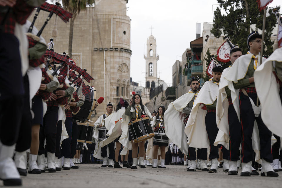 Palestinian scouts march during Christmas parade towards to the Church of the Nativity, traditionally believed to be the birthplace of Jesus Christ, in the West Bank town of Bethlehem, Saturday, Dec. 24, 2022. (AP Photo/Majdi Mohammed)