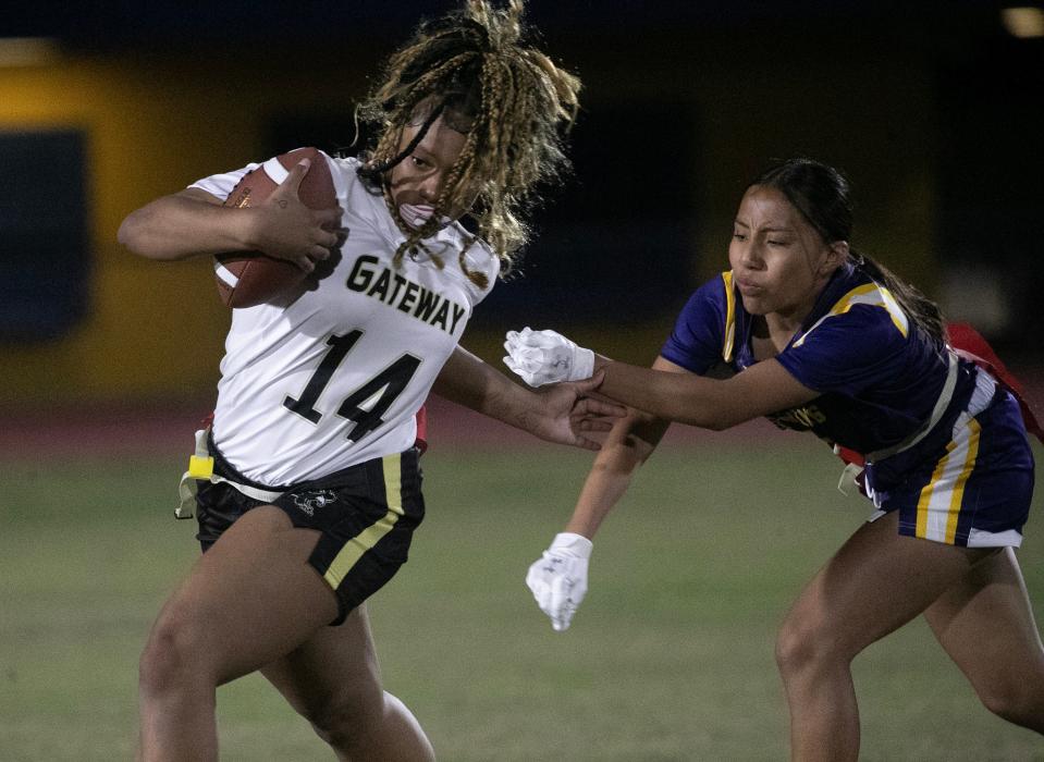 Gateway quarterback Amariyah Mullings tries to elude a Lehigh defender during a preseason girls flag football jamboree at Lehigh Senior High School on Tuesday, Feb. 13, 2024, in Lehigh Acres.