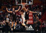 Dec 13, 2017; Miami, FL, USA; Portland Trail Blazers guard CJ McCollum (3) shoots the ball as Miami Heat center Kelly Olynyk (9) and guard Goran Dragic (7) defend during the first half at American Airlines Arena. Steve Mitchell-USA TODAY Sports
