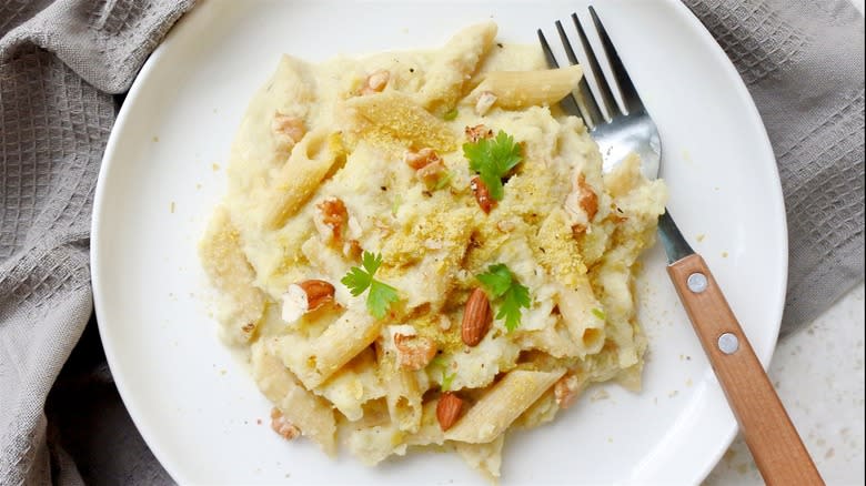 Vegan Alfredo pasta topped with nutritional yeast