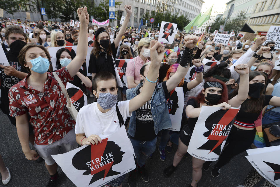 Protesters with a banner reading "Women's Strike" taking part in a rally against Polish government plans to withdraw from the Istanbul Convention on prevention and combatting of home violence,in Warsaw, Poland, Friday, July 24, 2020. In the opinion of Poland's right-wing government the convention promotes "gender" ideologies alien to Poland's Catholic tradition.(AP Photo/Czarek Sokolowski)