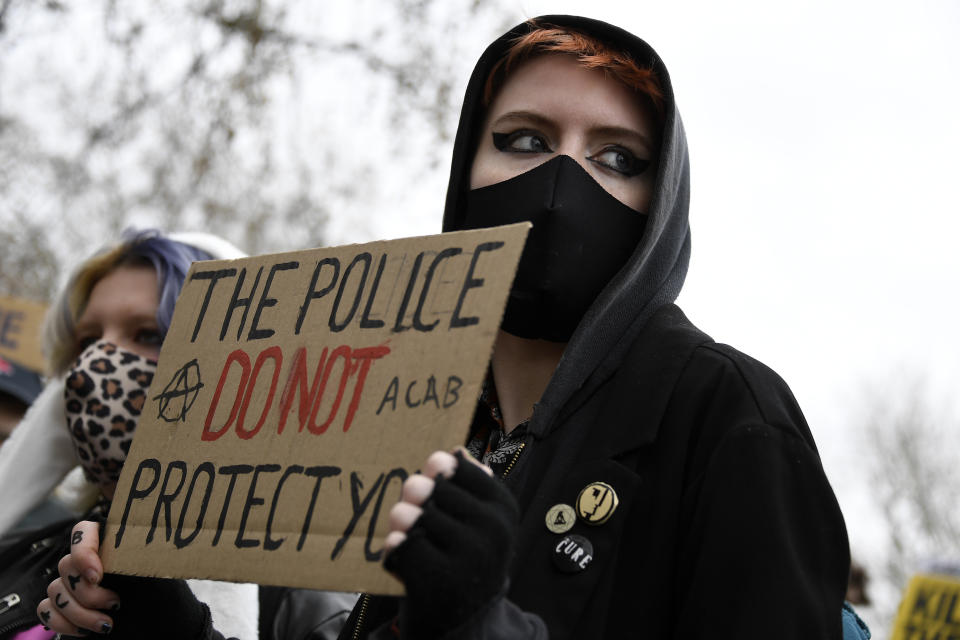 A demonstrator holds a poster during a 'Kill the Bill' protest at Hyde Park in London, Saturday, April 3, 2021. The demonstration is against the contentious Police, Crime, Sentencing and Courts Bill, which is currently going through Parliament and would give police stronger powers to restrict protests. (AP Photo/Alberto Pezzali)