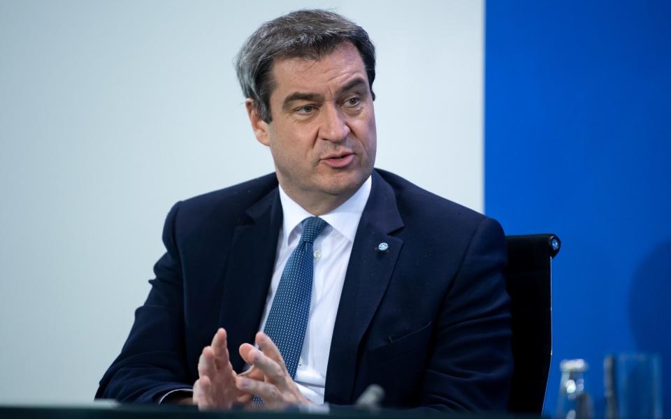 Bavarian Prime Minister Markus Soeder attends a news conference after discussing with German state premiers on whether to prolong or phase-out the lockdown to combat COVID-19 at the Chancellery in Berlin, Germany, April 15, 2020, as the spread of the coronavirus disease (COVID-19) continues in Munich. Bernd von Jutrczenka/Pool via REUTERS - via REUTERS