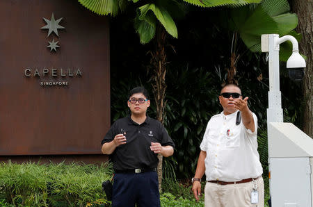 Hotel security guards stand in front of an entrance to the Capella Hotel, the venue for the June 12 summit between U.S. President Donald Trump and North Korean leader Kim Jong Un, on Singapore's resort island of Sentosa, June 9, 2018. REUTERS/Kim Kyung-Hoon