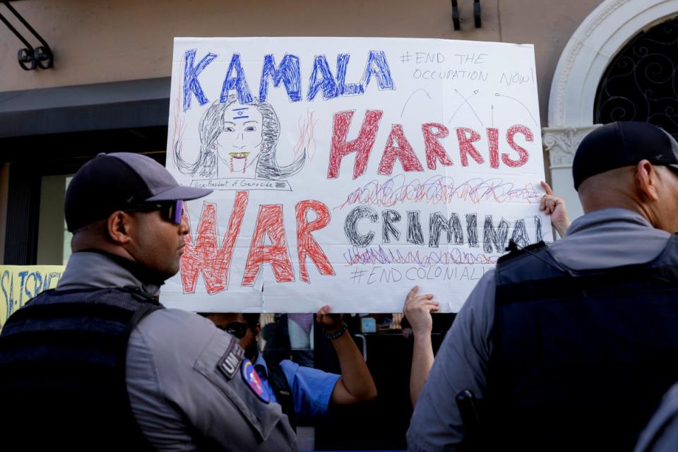 People protest outside the facility where Vice President Kamala Harris is holding a meeting, in San Juan, Puerto Rico (AP)