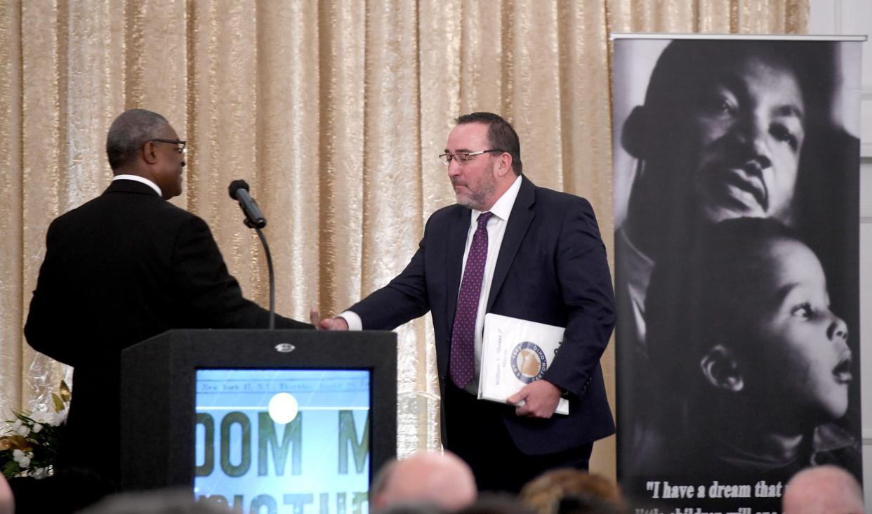 The Rev. Walter J. Arrington welcomes Canton Mayor William V. Sherer II to the podium for the 31st annual MLK Jr. Mayors' Breakfast in January at the DoubleTree by Hilton hotel downtown.