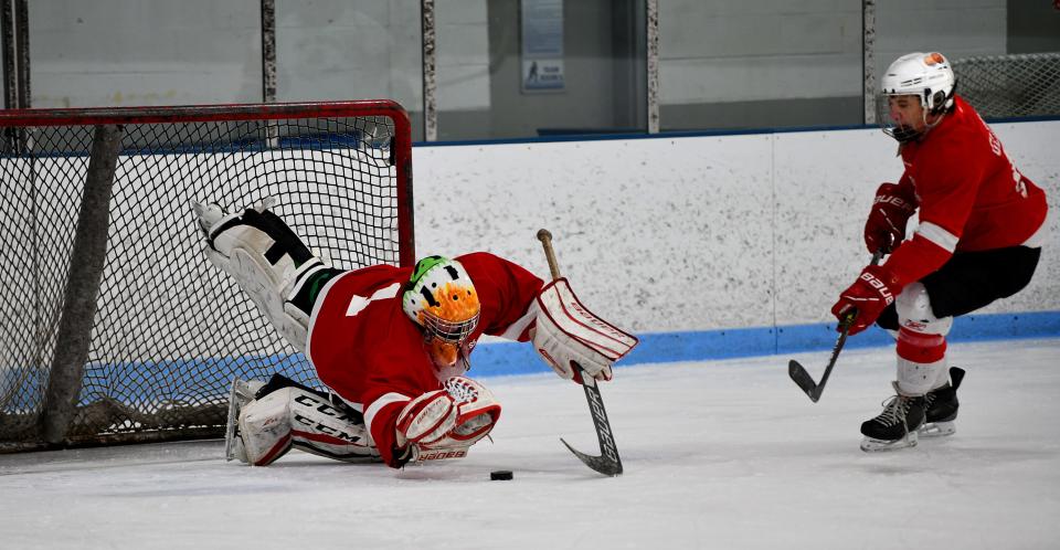 Goalie Jake Pruneau of Sterling jumps on the puck for a save during Central Mass Rusty Blades practice.