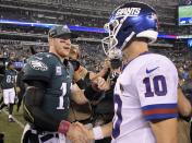 Philadelphia Eagles quarterback Carson Wentz (11) shakes hands with New York Giants quarterback Eli Manning (10) after an NFL football game Thursday, Oct. 11, 2018, in East Rutherford, N.J. The Eagles won 34-13. (AP Photo/Bill Kostroun)