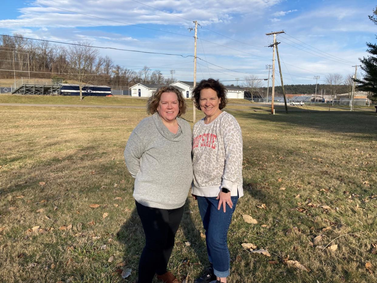 Amy Welsh, left, and Annie Quintrell, right, stand in the yard of Welsh's property at 534 New Burg St. in Granville Township with Granville High School's baseball field in the background. Welsh's property, as well as Quintrell's adjacent New Burg Street property, were recently added into the township's Open Space Program, forever protecting them from development.