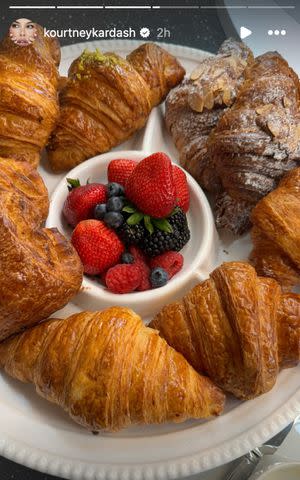 <p>Kourtney Kardashian/Instagram</p> Kourtney Kardashian Barker posts a photo of some croissants along with fruits to her Instagram Stories.