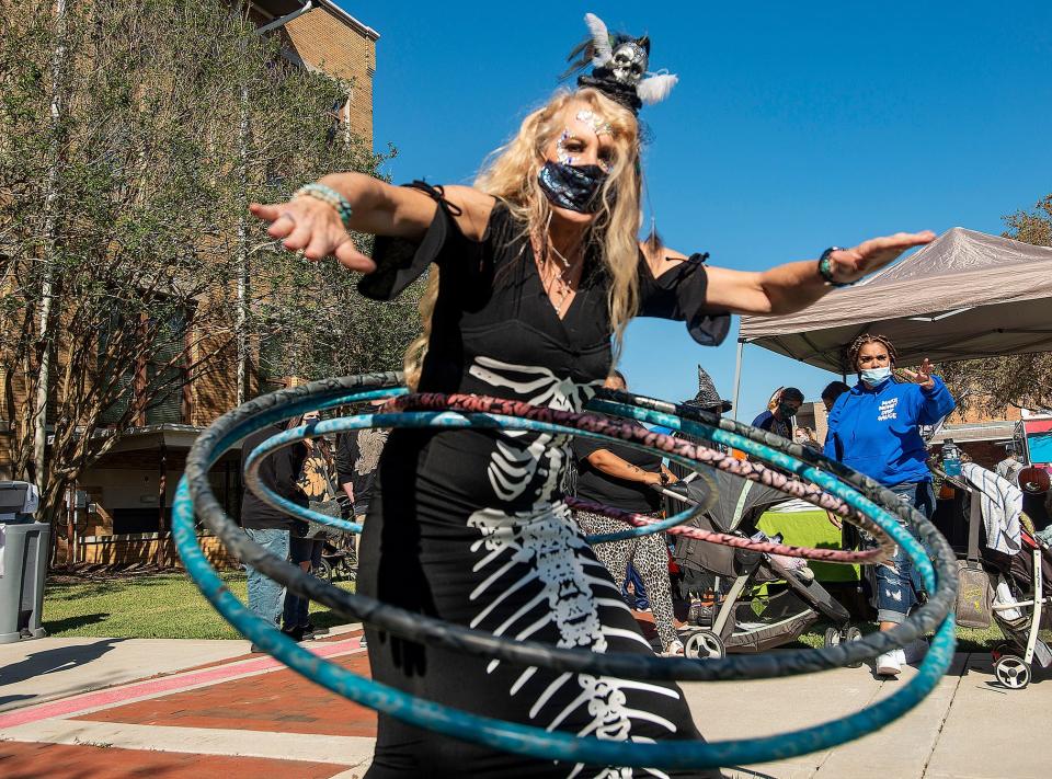 Laura Lee Nichols shows off her skills during the Pensacon HalloweenFest in 2020 at Museum Plaza in downtown Pensacola. Offering an outdoor, convention-style atmosphere with a Halloween theme, the day features vendors, live entertainment, celebrity guests, artists, panels, food trucks and trick-or-treating.Photos by John Blackie/jblackie@pnj.comLaura Lee Nichols shows off her skills during the Pensacon HalloweenFest Saturday, October 31, 2020 at Museum Plaza in downtown Pensacola. Offering an outdoor, convention-style atmosphere with a Halloween theme, the day features vendors, live entertainment, celebrity guests, artists, panels, food trucks and trick-or-treating.