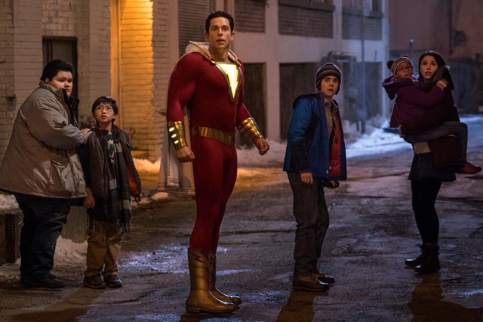 In this still from the 2019 film "Shazam!," Billy Batson (Zachary Levi, center) protects his foster siblings Pedro (Jovan Armand), Eugene (Ian Chen), Freddy (Jack Dylan Grazer), Darla (Faithe Herman) and Mary (Grace Caroline Currey).