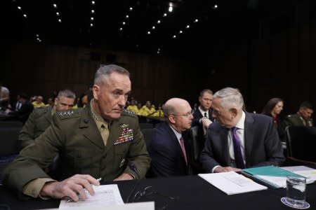 U.S. Defense Secretary Jim Mattis (R), and Joint Chiefs Chairman General Joseph Dunford (L) testify before a Senate Armed Services Committee hearing on  the “Defense Department budget posture in review of the Defense Authorization Request for FY2019 and the Future Years Defense Program” on Capitol Hill in Washington, U.S., April 26, 2018. REUTERS/Aaron P. Bernstein