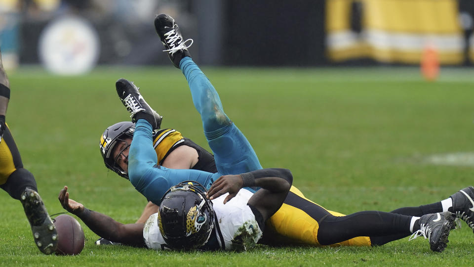 Jacksonville Jaguars running back Tank Bigsby (4) fumbles the ball after a hit by Pittsburgh Steelers linebacker Nick Herbig (51) during the second half of an NFL football game Sunday, Oct. 29, 2023, in Pittsburgh. (AP Photo/Matt Freed)