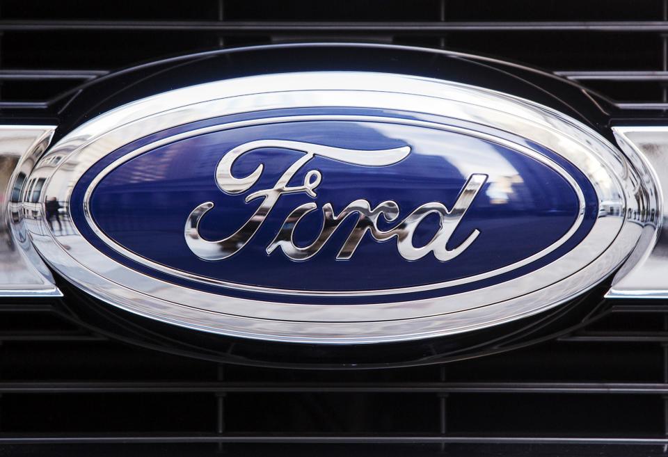 A Ford logo is seen on the grill of a 2015 F-150 truck outside the New York Stock Exchange in New York in this file photo taken January 13, 2014. Ford Motor Co posted lower-than-expected first-quarter profit on Friday as the No. 2 U.S. automaker saw higher warranty costs in North America for older vehicles by $400 million, sending shares down 2 percent in premarket trading. REUTERS/Lucas Jackson/Files (UNITED STATES - Tags: TRANSPORT BUSINESS)