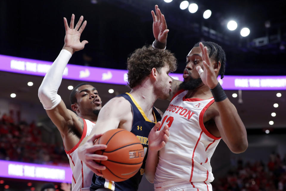 Northern Colorado forward Brock Wisne, center, is boxed up by Houston forwards Reggie Chaney, left, and J'Wan Roberts, right, during the first half of an NCAA college basketball game Monday, Nov. 7, 2022, in Houston. (AP Photo/Michael Wyke)