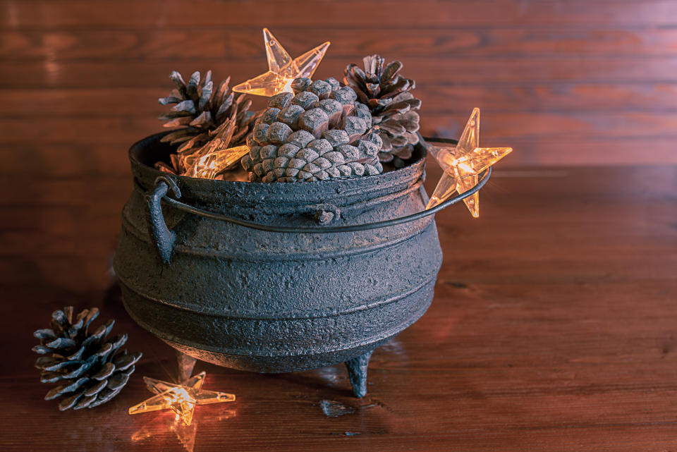 vintage metal kettle with pine cones. Rustic nordic scandinavian country cottage style decor. winter still life. (Getty Images)