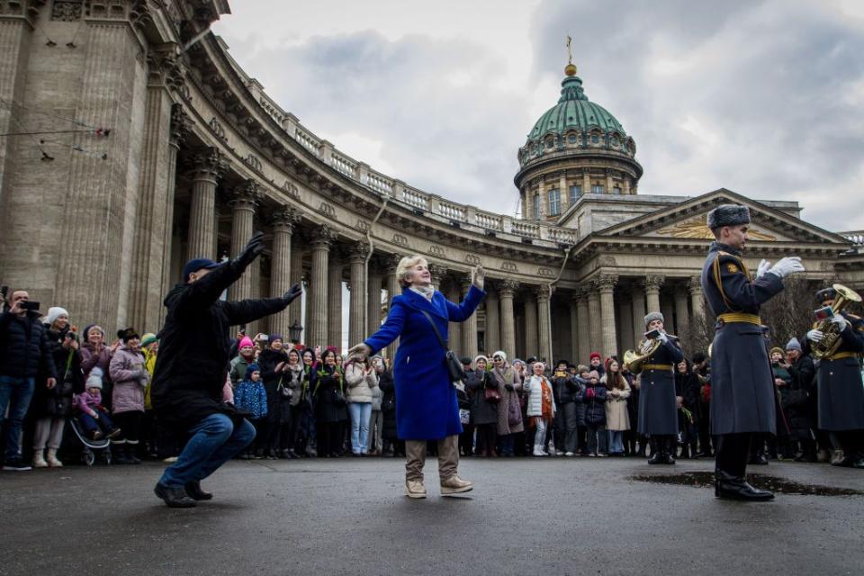 People dance during a musical performance by the Leningrad Military District Orchestra on the square near the Kazan Cathedral on March 8 in St. Petersburg, Russia. (Artem Priakhin/SOPA Images/LightRocket via Getty Images)