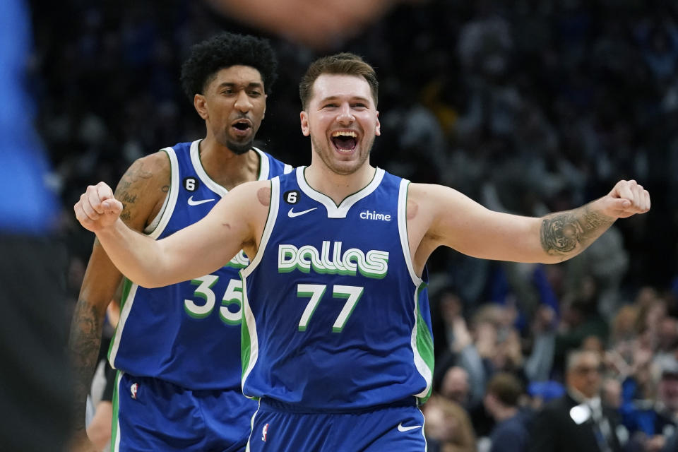 Dallas Mavericks guard Luka Doncic (77) celebrates scoring the game tying basket in front of teammate Christian Wood (35) during the fourth quarter of an NBA basketball game against the New York Knicks in Dallas, Tuesday, Dec. 27, 2022. The Mavericks won in overtime 126-121. (AP Photo/LM Otero)