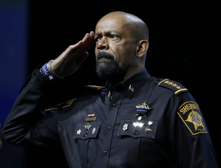 Sheriff David Clarke, Jr., of Milwaukee County, Wis., salutes the audience before his speech at the National Rifle Association convention Friday, May 20, 2016, in Louisville, Ky. (AP Photo/Mark Humphrey)