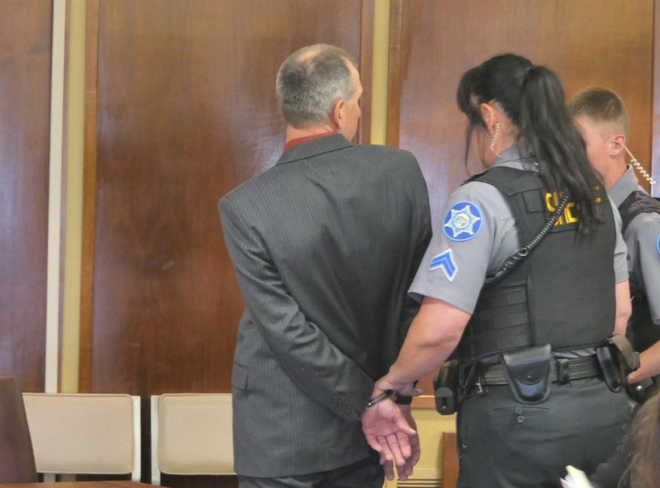 Todd W. Allen being handcuffed and led out of the courtroom at the Reno County District Courthouse during his sentencing on May 22, 2023.