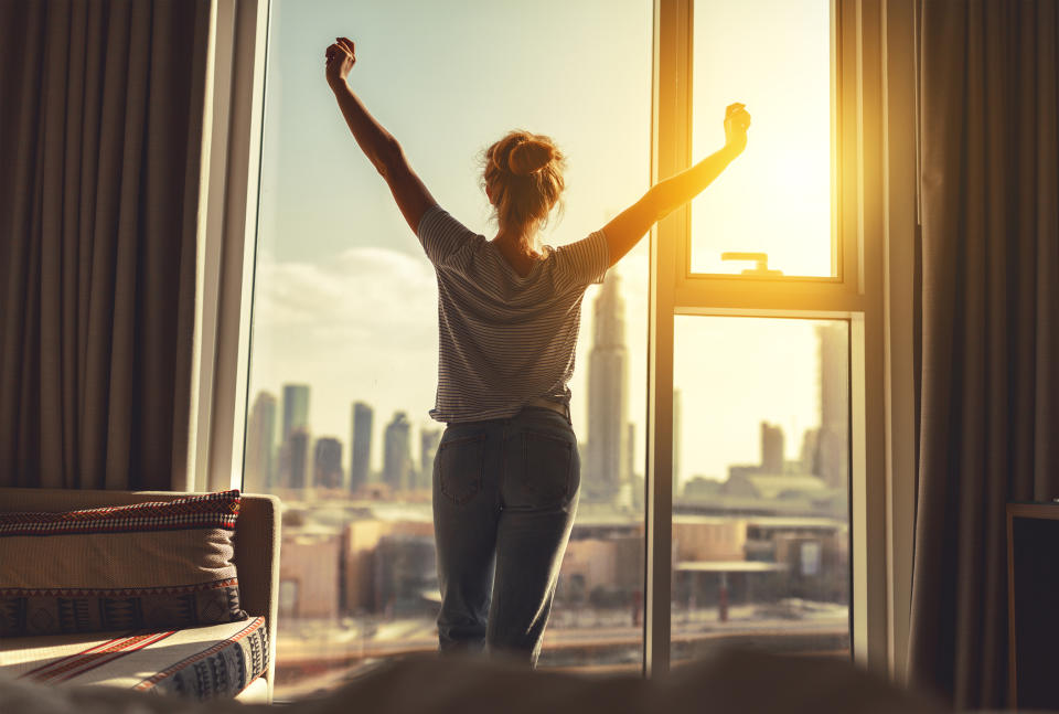 Woman getting out of bed happy. (Getty Images)