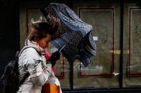 <p>People walk through Times Square during a winter nor’easter in New York City, March 2, 2018. (Photo: Brendan McDermid/Reuters) </p>