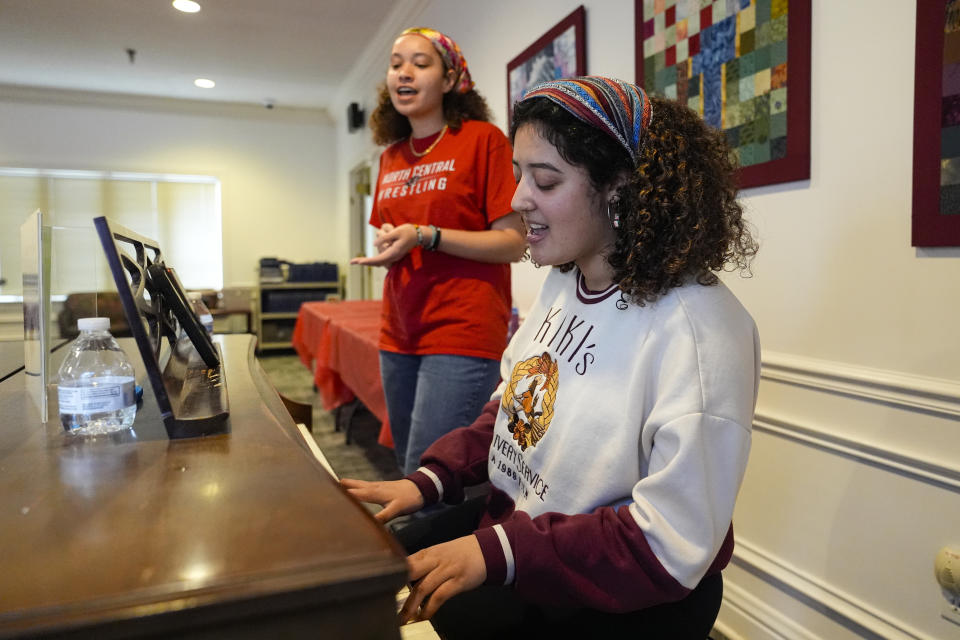 Hillary Haine, left, sings with Kim Gabriel at the Helene G. Simon Hillel Center at Indiana University in Bloomington, Ind., Tuesday, Feb. 13, 2024. An Indiana bill to address antisemitism on college campuses lost support from some members of the Jewish community after an amendment altered language surrounding criticism of Israel. (AP Photo/Michael Conroy)