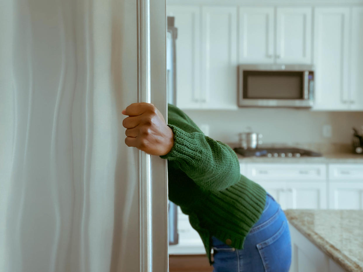 Woman looking in the fridge. (Getty Images)