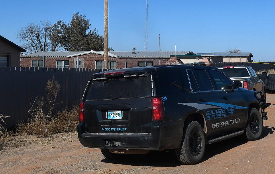 A Kingfisher County sheriff vehicle sits Nov. 21 at the scene near Lacey, Oklahoma, where four people were killed. State police in Oklahoma say that four people killed at a marijuana farm were "executed," and that they were Chinese citizens.