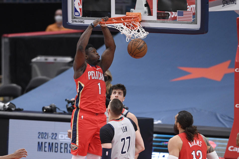 New Orleans Pelicans forward Zion Williamson (1) dunks over Washington Wizards center Alex Len (27) during the first half of an NBA basketball game Friday, April 16, 2021, in Washington. (AP Photo/Nick Wass)