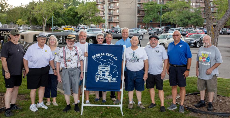 Members of the Floral City Model A Club stand near their group sign July 6 during a club meet at the Monroe Center for Healthy Aging.