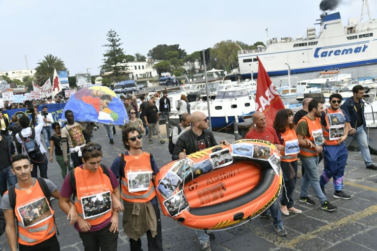 Protesters at G7 ministers meeting carry a rubber boat as they arrive on the Italian island of Ischia, to symbolize migrants who died at sea trying to cross the Mediterranean