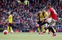 Manchester United's Bruno Fernandes scores his side's first goal of the game against Watford from the penalty spot during their English Premier League soccer match at Old Trafford in Manchester, England, Sunday Feb. 23, 2020. (Martin Rickett/PA via AP)