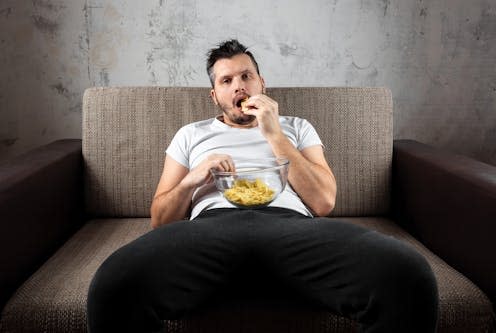   <span class="attribution"><a class="link " href="https://www.shutterstock.com/image-photo/guy-shirt-lying-on-couch-eating-1285351615" rel="nofollow noopener" target="_blank" data-ylk="slk:Marko Aliaksandr/Shutterstock;elm:context_link;itc:0;sec:content-canvas">Marko Aliaksandr/Shutterstock</a></span>