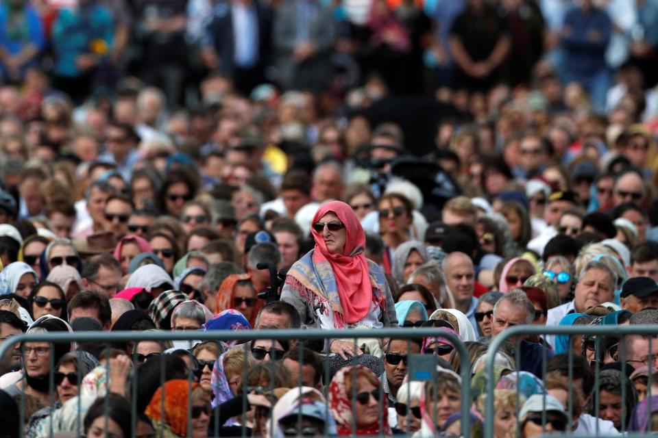 People attend the Friday prayers at Hagley Park outside Al-Noor mosque in Christchurch (REUTERS)