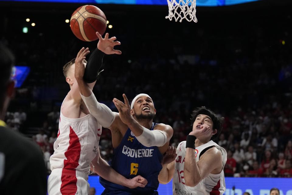 Cape Verde forward Ivan Almeida (6) shoots against Japan center Josh Hawkinson (24), left, and Japan forward Yuta Watanabe (12) in the second half of their Basketball World Cup classification match in Okinawa, southern Japan, Saturday, Sept. 2, 2023. (AP Photo/Hiro Komae)