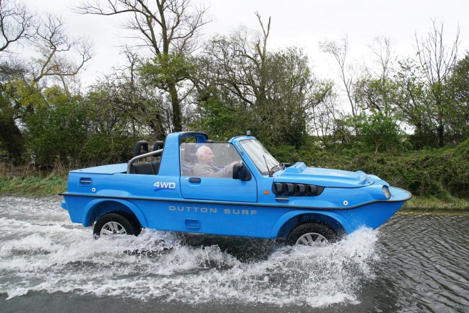 A car drives through floodwater in Littlehampton, West Sussex, after the River Arun burst its banks overnight (PA)