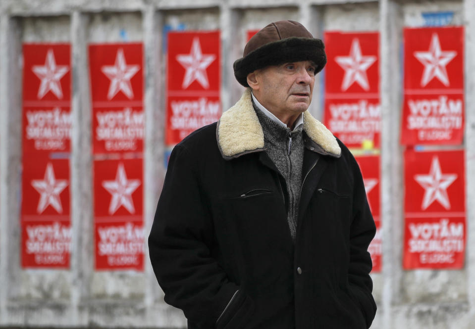 A man walks by electoral posters advertising the candidates of the Socialists' Party, in Chisinau, Moldova, Thursday, Feb. 21, 2019, ahead of parliamentary elections taking place on Feb. 24. Moldova's president says the former Soviet republic needs good relations with Russia, amid uncertainty about the future of the European Union.(AP Photo/Vadim Ghirda)