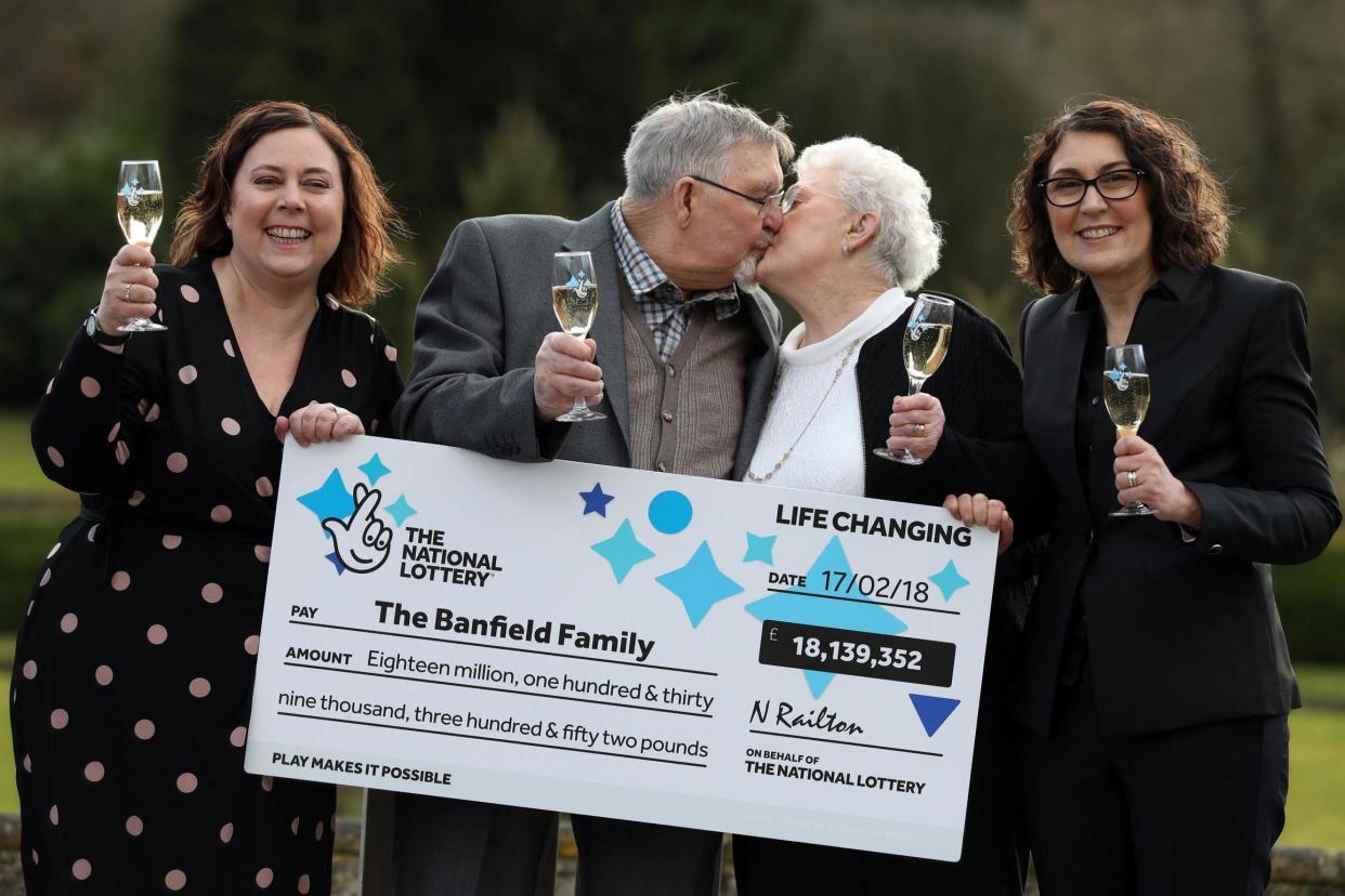 Dennis and Shirley Banfield celebrate their win with daughters Tina Burgess, 54, and Karen Maddock, 51: PA