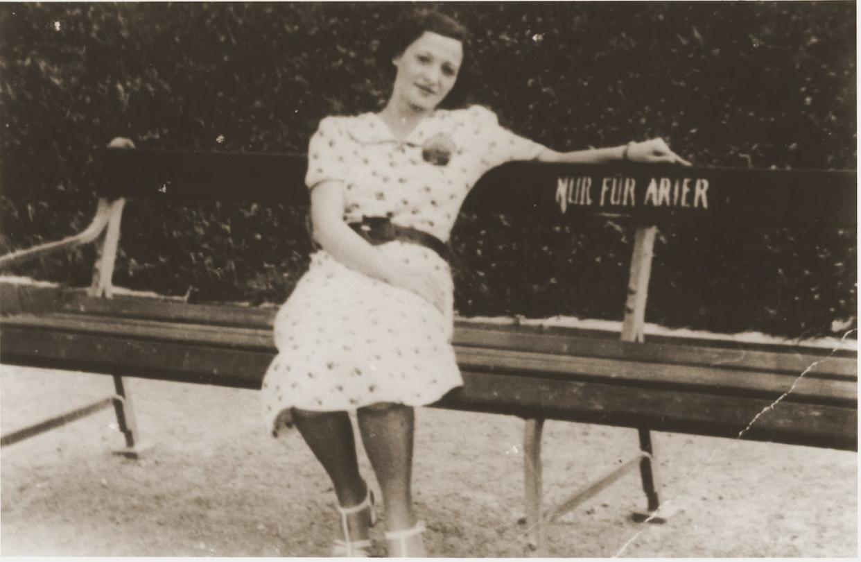 Lizi Rosenfeld, a Jewish woman, sits on a park bench bearing a sign that reads, 'Only for Aryans,' in August 1938 in Vienna. <a href="https://collections.ushmm.org/search/catalog/pa1102831" rel="nofollow noopener" target="_blank" data-ylk="slk:United States Holocaust Memorial Museum /Provenance: Leo Spitzer;elm:context_link;itc:0;sec:content-canvas" class="link ">United States Holocaust Memorial Museum /Provenance: Leo Spitzer</a>, <a href="http://creativecommons.org/licenses/by-sa/4.0/" rel="nofollow noopener" target="_blank" data-ylk="slk:CC BY-SA;elm:context_link;itc:0;sec:content-canvas" class="link ">CC BY-SA</a>