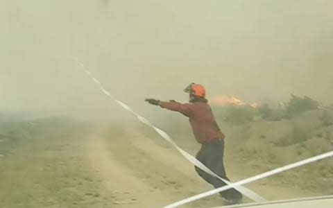 A firefighter races to secure the hose - Credit: INSTAGRAM @MAR.LOWSKY